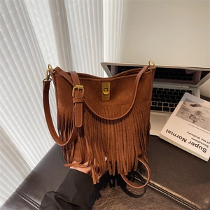 Detailed close-up of brown suede bucket bag featuring long fringes and gold twist lock