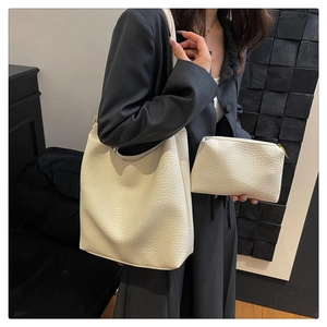 Detail of off-white lychee texture tote bag set with small zipper pouch and wide strap
