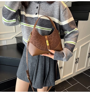 Detail of a brown leopard print patchwork handbag with golden square lock and strap