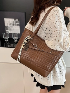 Brown woven texture tote bag with stylish chain charm and shoulder strap for women