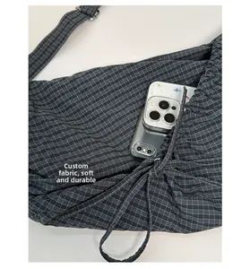 Detail of custom soft grey checkered fabric shoulder bag showing interior storage capacity