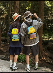 Detailed back view of colorful hiking backpacks with mesh pockets and X-elastic cords
