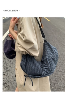 Blue-grey plaid hobo bag with large capacity shown in a stylish outdoor model street view