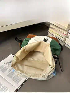 Macro view of the spacious internal capacity and neat stitching of the nylon backpack
