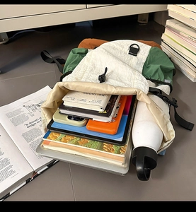 Top-down view of large capacity school backpack interior showing organized laptops and books