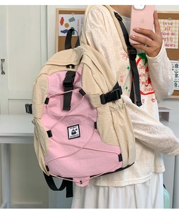 Pink and beige waterproof nylon backpack with elastic cord detail and Penguin logo