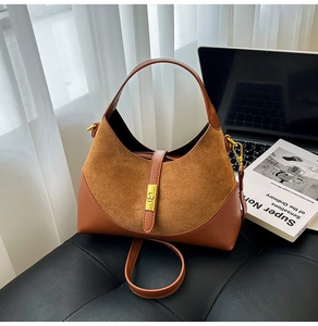Detail view of contrast suede and smooth leather bag with golden twist lock and shoulder strap