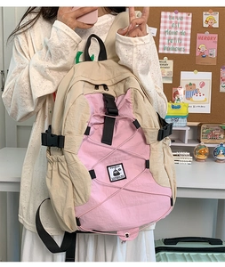 Close-up of lightweight nylon student backpack with pink and beige patchwork design