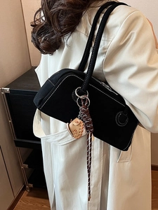 Vintage matte Boston bag with contrast stitching and baseball glove charm on model