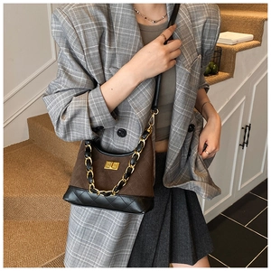 Detail of vintage quilted leather shoulder bag with gold chain and turn-lock closure