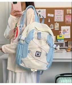 Detail of the multi-functional buckle and elastic fixing rope on the casual school bag