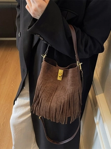 Vintage dark brown suede fringe bucket bag with golden buckle and crossbody strap