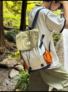 Close-up of color-block backpack showing green flap and durable waterproof fabric texture