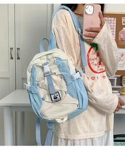 Detail view of lightweight blue and white canvas backpack with penguin brand logo