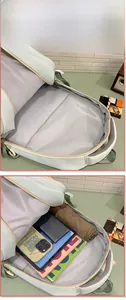 Detail view of mint green backpack interior with padded laptop sleeve and spacious storage
