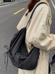 Minimalist black and white plaid canvas crossbody bag with drawstring and bow detail