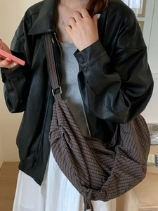 Large checkered hobo bag in deep brown canvas with adjustable strap shown on model