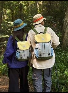 Close-up of lightweight water-resistant nylon backpacks in yellow and green outdoor settings
