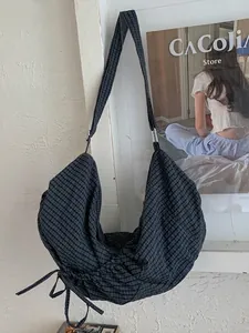 Black checkered large hobo bag with drawstring detail and adjustable strap