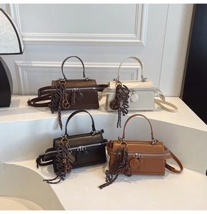Detail showing the stylish PU leather small square bags in four classic colors with charms
