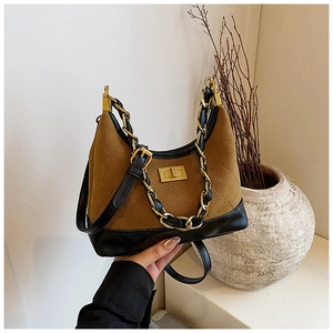 Close-up of vintage hobo bag with quilted leather texture and golden metal chain strap