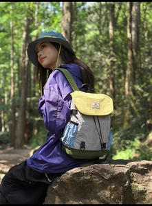 Outdoor view of multi-color nylon backpack with yellow flap and side pockets
