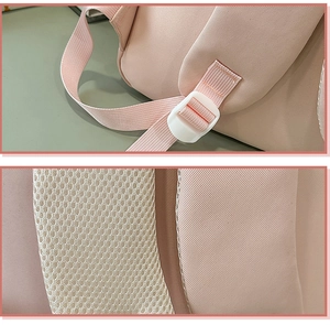 Detail of adjustable straps and breathable honeycomb mesh padding on pink backpack