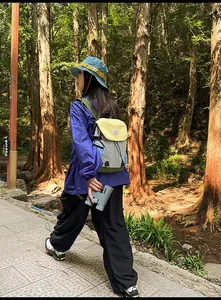 Detailed outdoor view of a colorful patchwork backpack with ergonomic straps for hiking