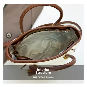 Internal view of beige shoulder bag with brown trim and zip closure detail
