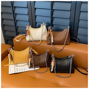 Detail shot of woven crossbody bags in five colors with chain and wooden beads