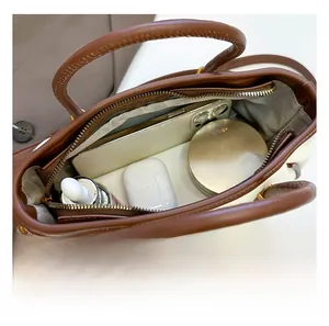 Detail showing high-capacity interior of the vintage bucket bag with multiple storage items
