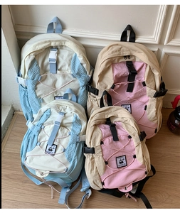 Comparison of two sizes of color-block nylon backpacks in blue and pink colorways