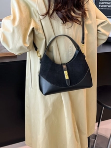 Contrast suede and leather dumpling bag in black with gold hardware and top handle