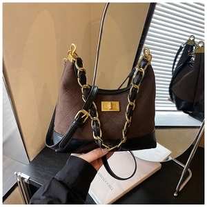Detail of vintage quilted chain shoulder bag with gold twist lock and brown faux suede