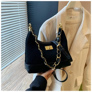 Detail of black quilted leather hobo bag with gold chain strap and turn-lock closure