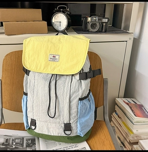 Detailed close-up of a colorful nylon backpack with buckle straps and a drawstring closure