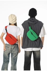 Detailed back view of red and green nylon crossbody chest bags with adjustable straps