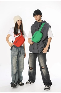 Detailed view of red and green sporty crossbody chest bags on male and female models