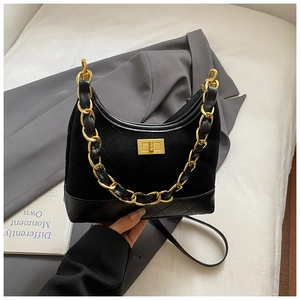 Detailed view of black quilted leather hobo bag with gold chain strap and turn-lock