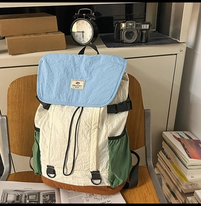 Close-up of a multi-color casual backpack with vintage nylon texture and drawstring detail