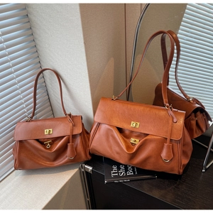 Detailed view of brown leather tote bags with gold twist locks and shadow effects