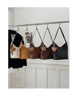Collection of minimalist woven leather bucket bags in five colors with cute bear charms