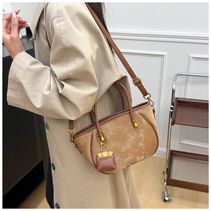 Detail of camel suede tote bag with detachable strap and mini pouch on model