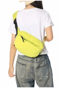 Detail view of the lightweight fluorescent yellow nylon waist bag with adjustable strap