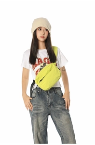 Detail view of neon green nylon crossbody bag with zipper and adjustable strap