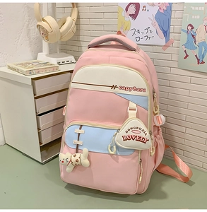 Pink student backpack with large capacity, multi-compartment design and cute plush pendants