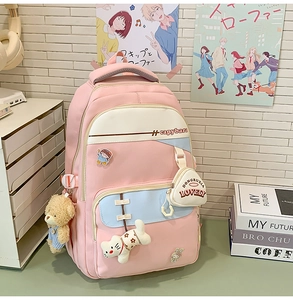 Pink and blue canvas backpack with cute plush pendants and capybara print details