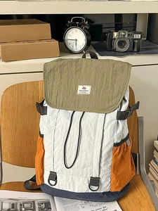 Multicolor minimalist casual backpack for college students on a vintage wooden chair