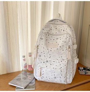 Detail of star pattern backpack showing the leather label on soft canvas material