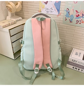 Detail view of the breathable padded shoulder straps on the light green student backpack